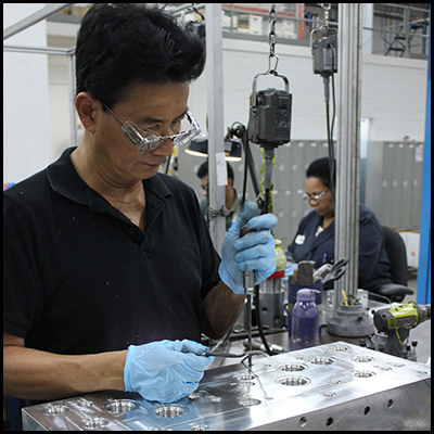 Man with protective gear using machine
